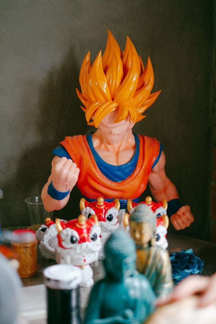 gallery-6 A vibrant display of anime figurines including Goku amidst various collectibles against a gray background.