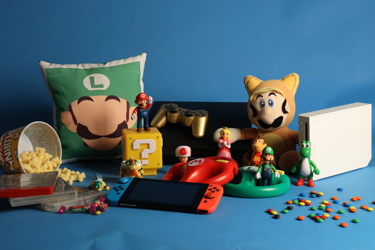 A vibrant assortment of gaming collectibles, including Nintendo figures, consoles, and candy on a blue background.