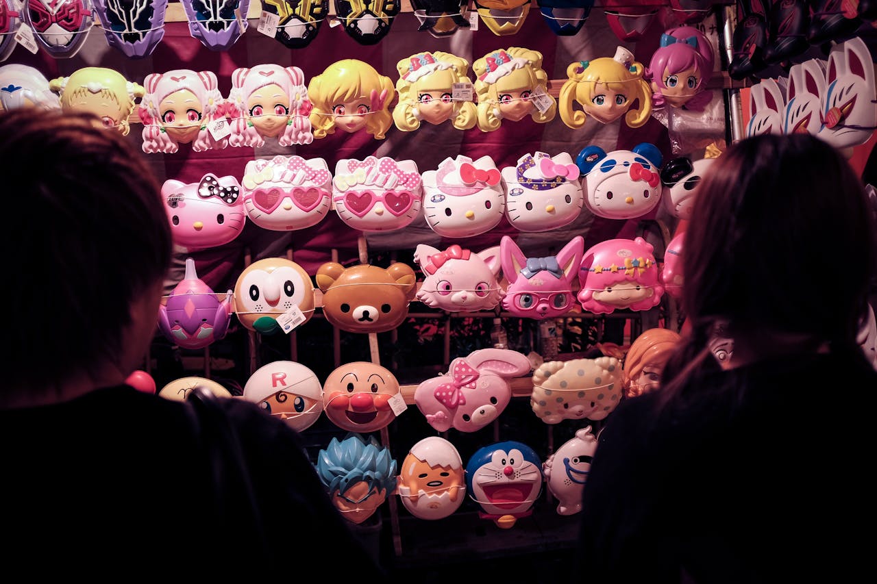 Colorful anime masks for sale at a bustling Tokyo market stall, Japan.